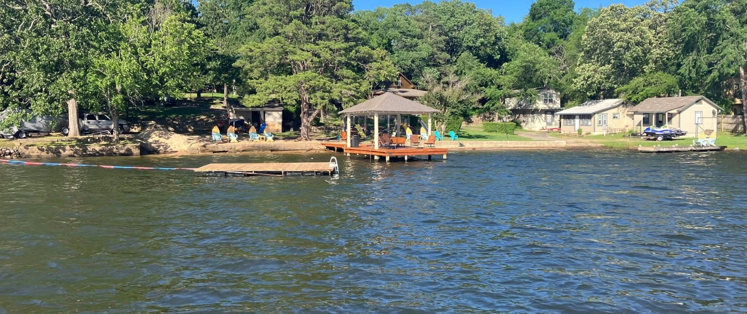View from Lake Hamilton at Knollwood Lodge lakefront cabin rentals looking toward the dock and gazebo