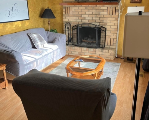 Cozy living room with fireplace inside family cabin rental near Lake Hamilton