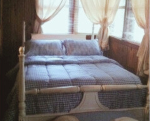 Private bedroom with one full-size bed in Cabin 2 – Hot Springs lakefront rental