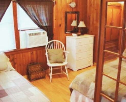 Cozy bedroom with two full-size beds in Cabin 3 – quiet Hot Springs lodging