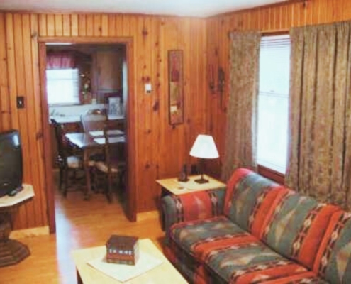 Comfortable living room couch in Cabin 3 – simple and relaxing cabin interior