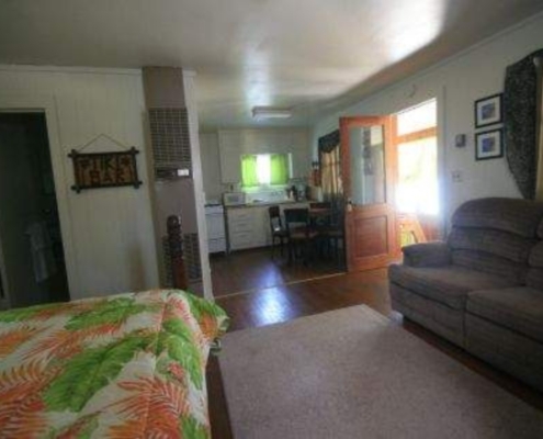 Cabin 7 living room featuring one full-size bed and cozy seating at Knollwood Lodge