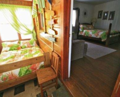 Climate-controlled porch in Cabin 7 with two full-size beds, perfect for family or guests