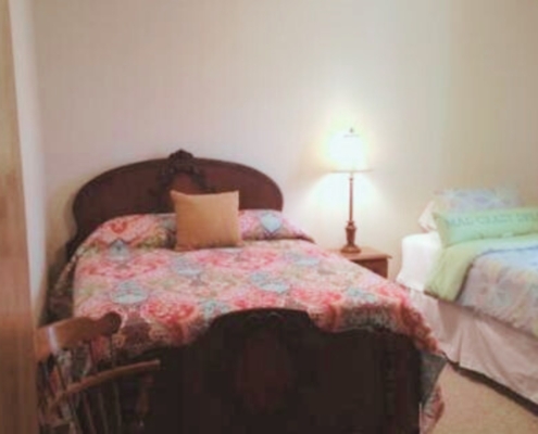 Second bedroom featuring a queen bed and a twin bed.
