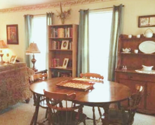 Dining room with a wooden table and seating for multiple guests.