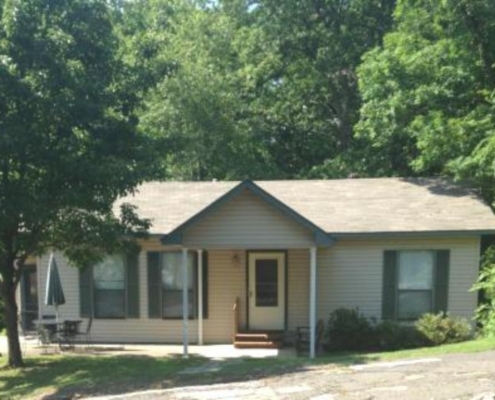 Exterior view of Cabin 10 surrounded by trees.