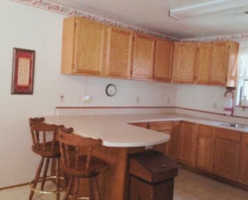 Kitchen view highlighting the bar seating area.